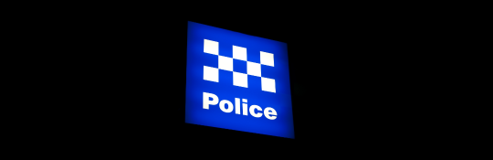 Lit-up Police sign in blue and white