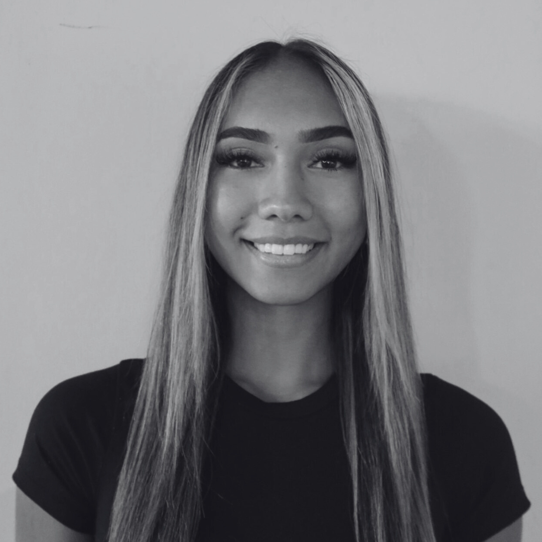 Headshot of Maikiira Barber smiling. She has long, straight hair and is wearing a black tee shirt.