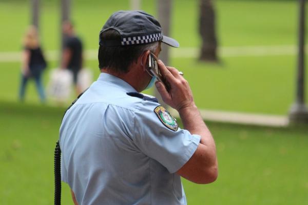 NSW Police officer making a phone call.